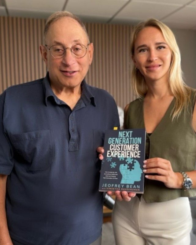 Jeofrey Bean and Ekaterina Mironova with a copy of The Next Generation Customer Experience book